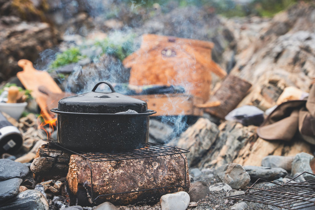 Pot boiling over an open fire on the Newfoundland coastline at a beach boil up
